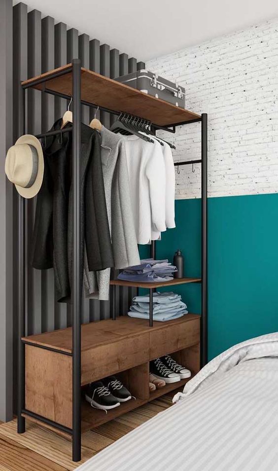 Foto de um armário arara com peças de roupas de um armário cápsula masculino.